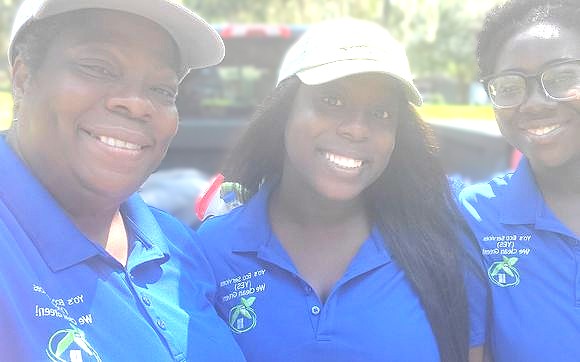 Yo’s Eco Services team members wearing royal blue company shirts